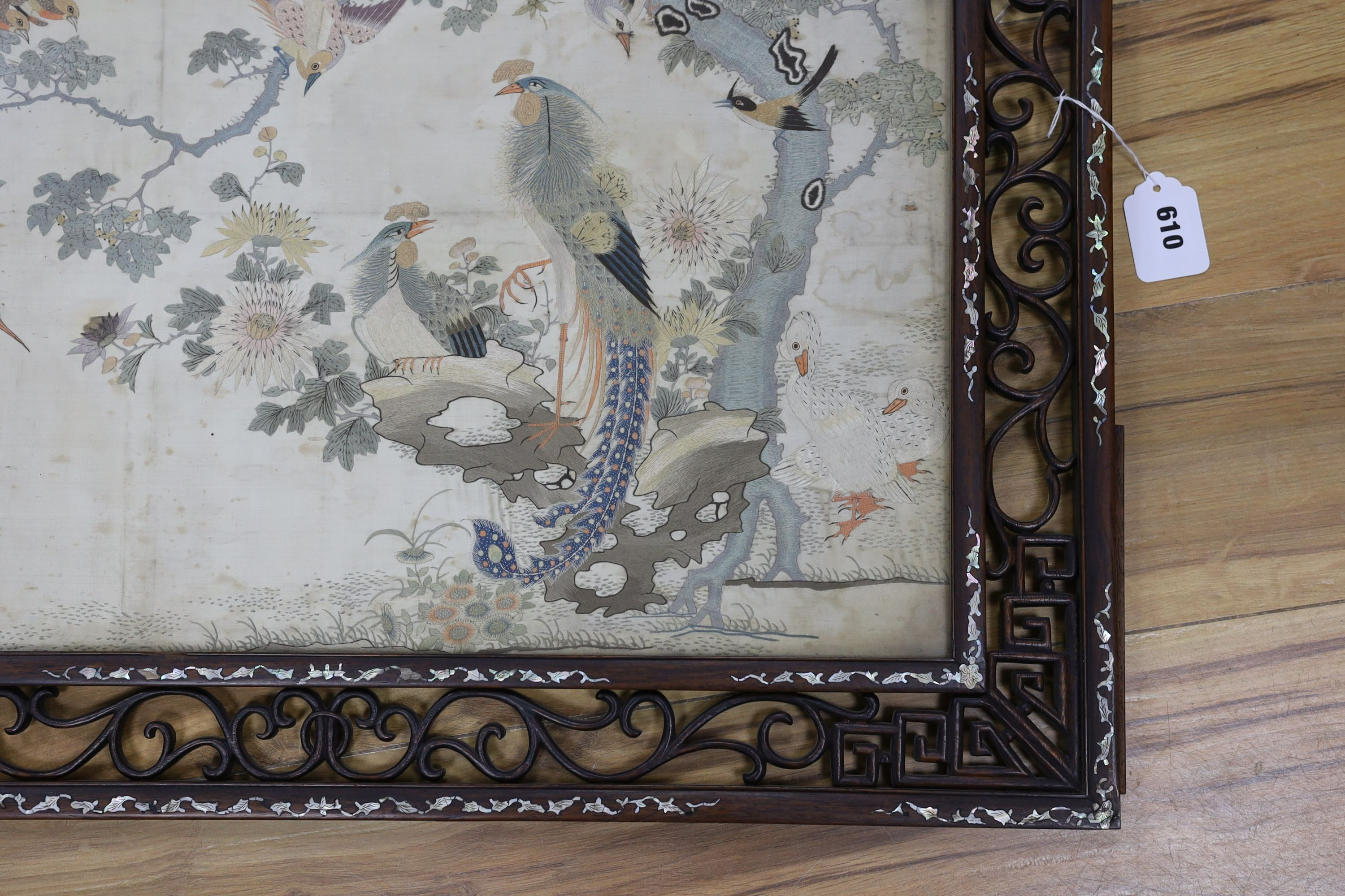 A Chinese mother of pearl inlaid framed and inscribed silk embroidery ‘of the hundred birds’, 78cms wide, 59cms high (including frame)